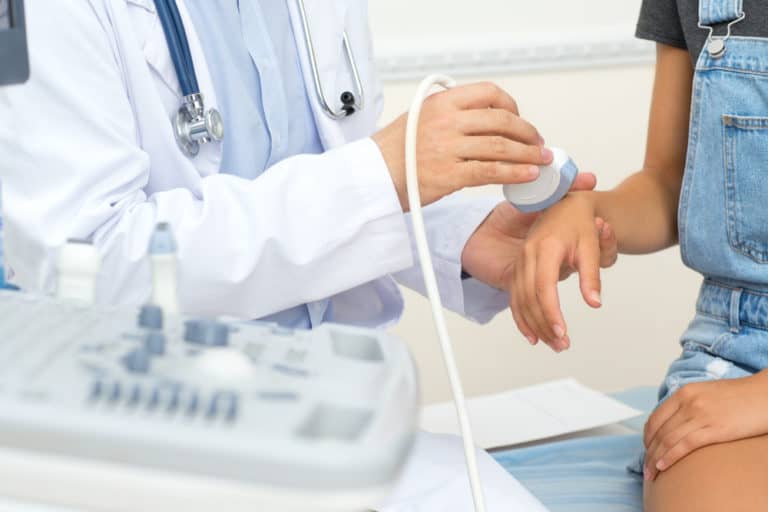 doctor examining patient's hand